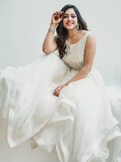 A bright and airy portrait in a white gown. The high-key lighting creates a soft, ethereal feel, perfect for showcasing delicate fabrics and creating a gentle, classic image.