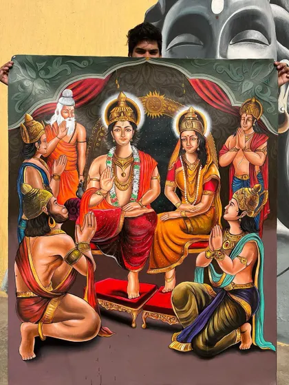Holding up my completed Ram Darbar painting. This large acrylic on canvas piece is one of my most detailed works, showing the full divine family.