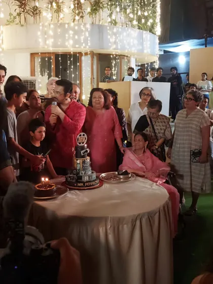 The legendary Aamir Khan addressing his family and friends during his 60th birthday celebration, with our cinematic-themed cake right beside him.
