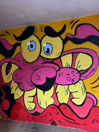 A tight shot of the Courage the Cowardly Dog mural, focusing on his iconic expression of panic. This piece is all about bold colors and high energy.