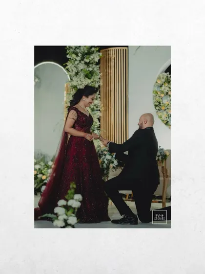 A classic proposal moment captured during the reception, with the groom on one knee. It's a timeless shot that every couple cherishes.