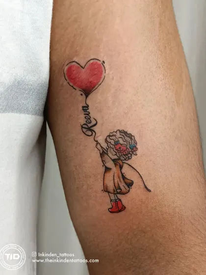 A close-up of the father-daughter balloon tattoo.