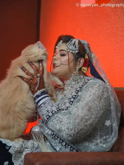 A second shot of the bride with her cat, showing the tender interaction. Including pets in wedding photos makes the memories even more personal and special.