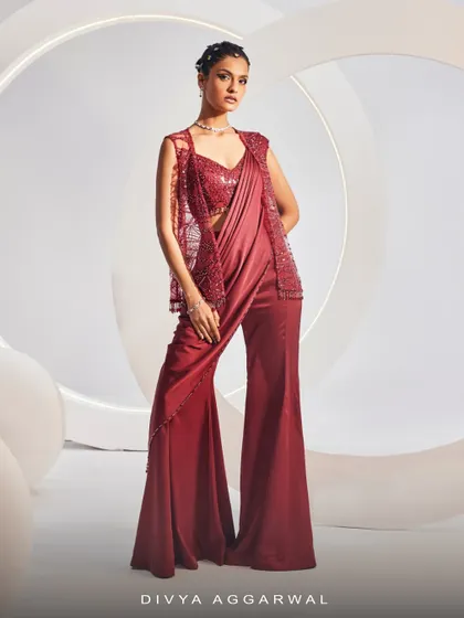 The NAIDA Sharara Saree Set, showcasing its breathtaking silhouette, intricate embroidery, and shimmering accents from a side angle.