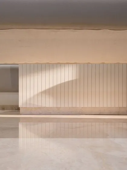 A playful shot showing the details of the dining bench legs and the reflection on the polished Italian marble floor. Every detail is considered.