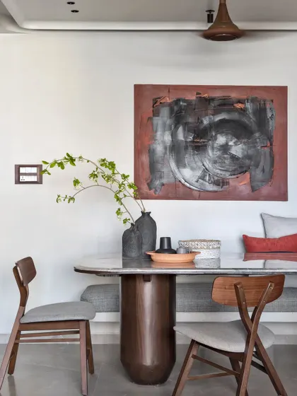 I call this visual poetry. The abstract artwork, custom bench seating, and sculptural dining table create a scene that is impactful yet calming, perfect for shared meals.