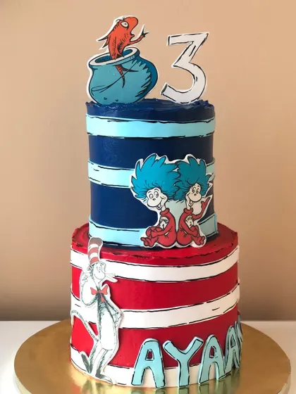 "Why fit in when you were born to stand out?" This Dr. Seuss cake, inspired by 'The Cat in the Hat', is a tribute to fun, imagination, and being unique.