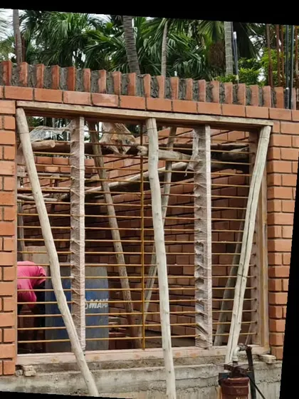 A window detail in an exposed brick wall under construction.