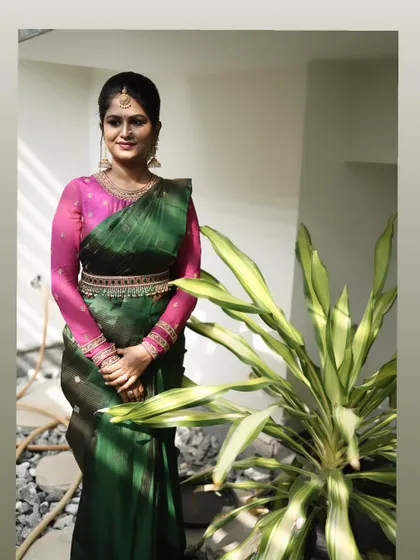 A full-length shot of Dr. Meghana's pre-wedding ritual look. The makeup is classic and enhances her beautiful features.
