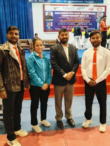 With fellow coaches and officials at the Ghaziabad District Taekwondo Championship.