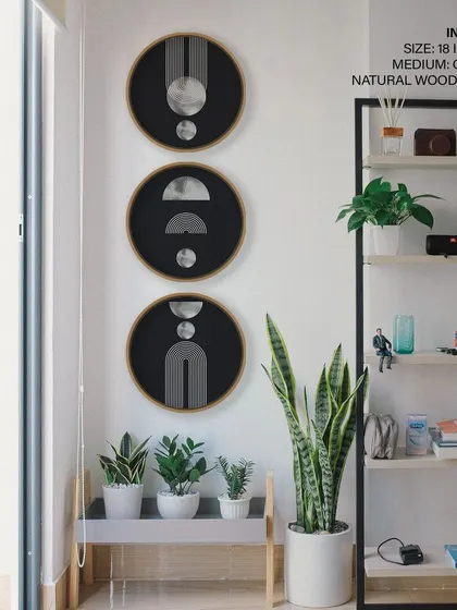 This set of three circular prints features Scandinavian mid-century abstract designs. The black, white, and silver geometric shapes create a sophisticated and timeless look, perfect for a modern interior.