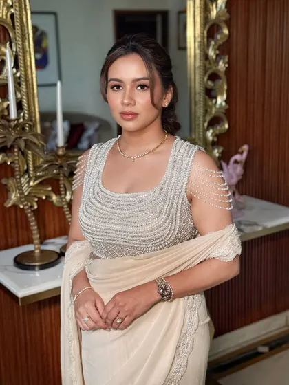 This portrait showcases the complete look, where the minimal makeup allows the intricate outfit and the bride's natural beauty to be the focus.