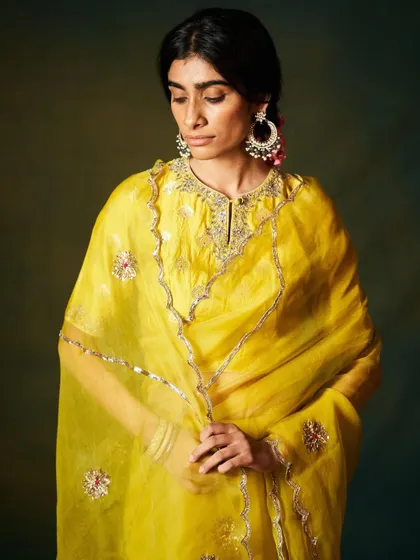 A closer look at the craftsmanship on the yellow organza saree. The detailed neckline and sheer dupatta showcase the artistry that goes into each piece I select for my clients.