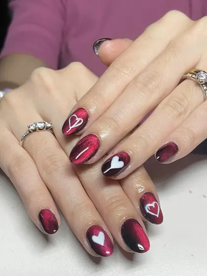 A red cat-eye base with hand-painted white hearts. This is a sweet and romantic design, perfect for Valentine's Day or any time of year.