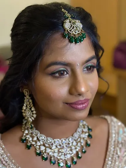 A close-up of Deekshida's bold reception glam. The holographic green glitter liner adds a striking and unique touch to her eye makeup.
