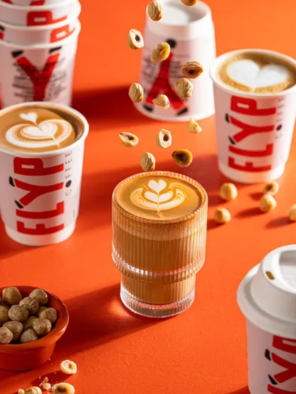 Another look at our levitating hazelnut concept for Flyp Coffee. This composition, with multiple cups and floating nuts, creates a visually busy and engaging scene that draws the eye.