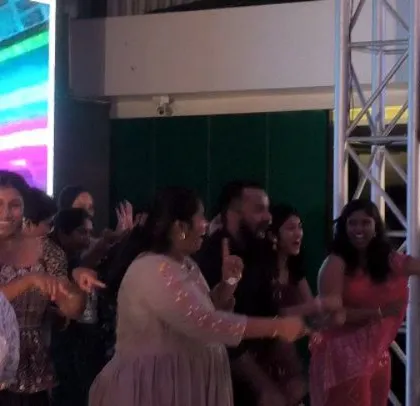 The dance floor is full of happy guests.
