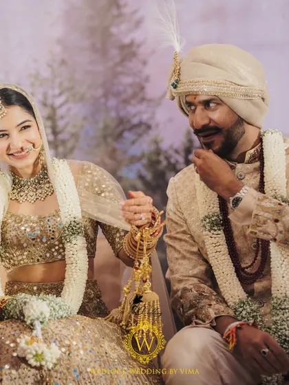 A bride in her stunning vintage lehenga, perfectly complemented by the minimalist decor of whites and greens. The focus remains on the couple's love story, enhanced by a simple and elegant setting.
