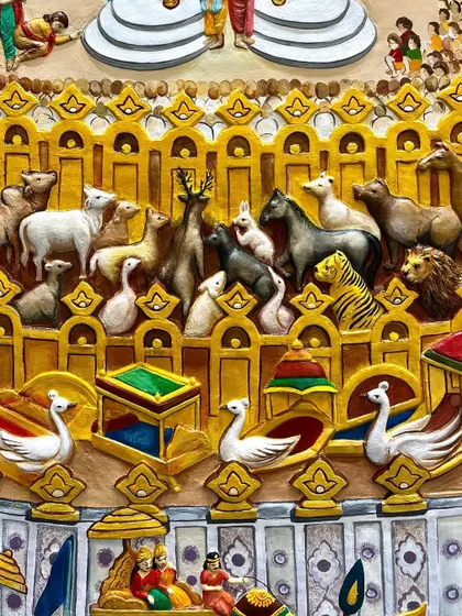 A close-up showing the animals gathered peacefully to hear the sermon, a key feature of the Samavasarana. Each animal is sculpted with care.