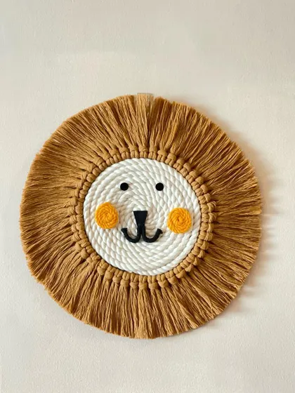 The king of the jungle in macrame form! This lion face wall hanging with its full, fringed mane and sweet expression is a favorite for kids' rooms.