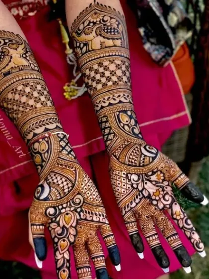 This design features elephants and peacocks on the arms, with a mix of floral and jaali work on the hands.