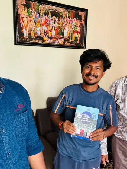 Our team with a customer holding our "Built for Generations" booklet. We are your trusted partner for the long run.