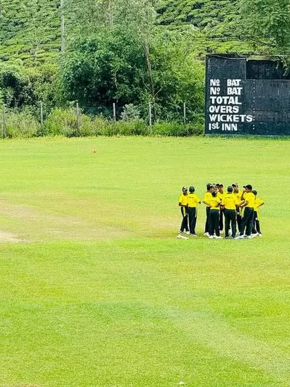 The U-16 team huddles near the scoreboard during their Sri Lanka tour, discussing tactics for the next phase of the game.