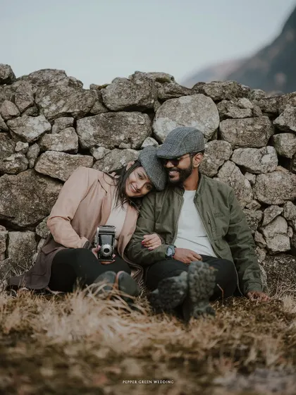 A quiet moment of rest for Ananthu and Sarga against an old stone wall. This shot captures a feeling of peaceful companionship and timeless love.