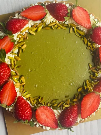 This Pistachio Strawberry Tart features a smooth, creamy pistachio filling, encircled by a border of fresh, juicy strawberries and crunchy pistachio slivers.