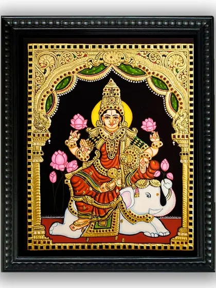 The framed version of our Lakshmi on Airavata Tanjore painting. The classic frame adds a finishing touch, making it a ready-to-hang masterpiece of devotional art.