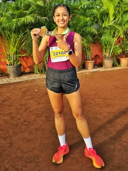 Holding my medal after a tough hilly half marathon. The process of pushing your limits is what creates the strongest version of you.