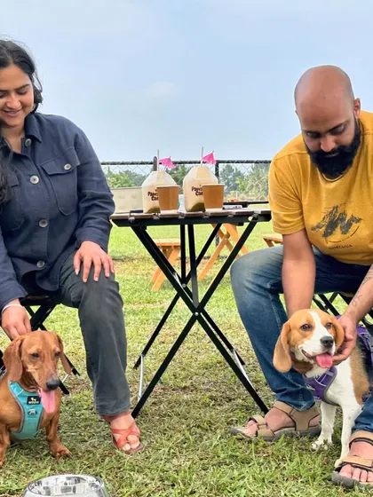A couple enjoying a quiet moment with their dachshund and beagle at our cafe.