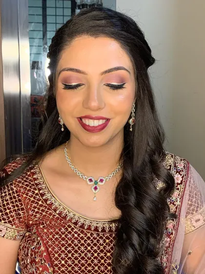 This is a gorgeous, unedited reception look. Notice how the shimmering eyeshadow and rich berry lip come together to create a look that is both elegant and celebratory.