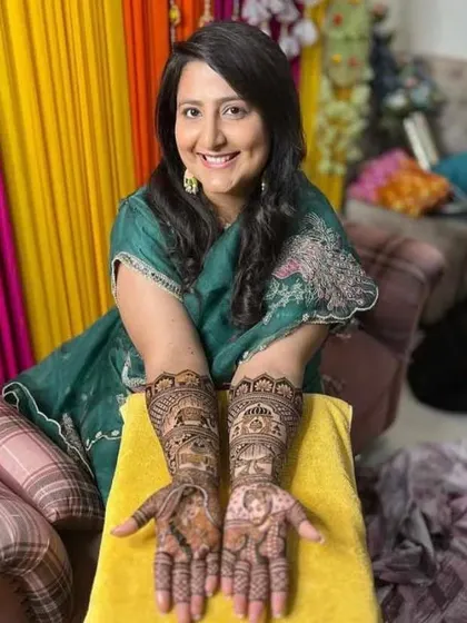 This bride is all smiles as she shows off her custom portrait mehendi. I travel to your home anywhere in Mumbai so you can get your bridal henna done in comfort.