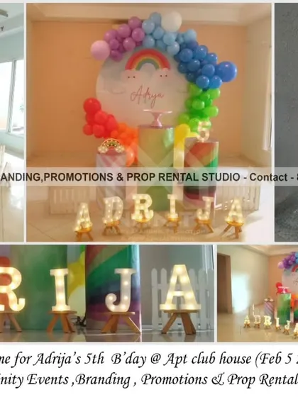 A beautiful rainbow theme for a 5th birthday at an apartment clubhouse. The decor includes a circular backdrop with a vibrant rainbow balloon arch, a light-up number "5," and marquee letters for a bright and cheerful celebration.
