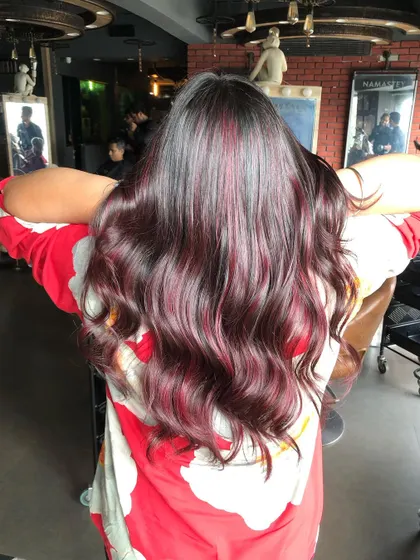 This Red Wine Balayage looks stunning from every angle, perfectly complementing dusky Indian skin tones.