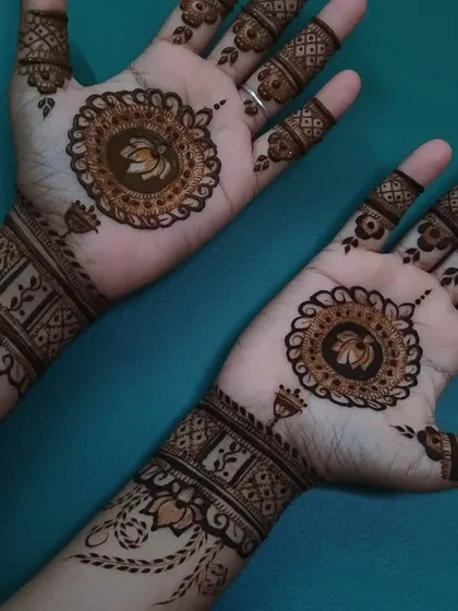 A beautiful pair of hands with matching lotus mandala designs and wristbands. This is a classic and elegant choice for any occasion.