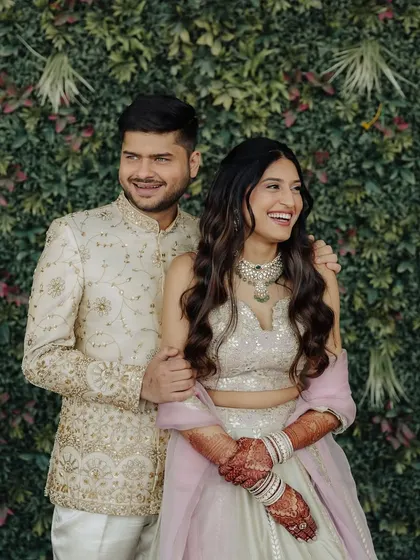A happy, candid couple shot. The bride's soft waves and minimal makeup create a relaxed and elegant engagement look.