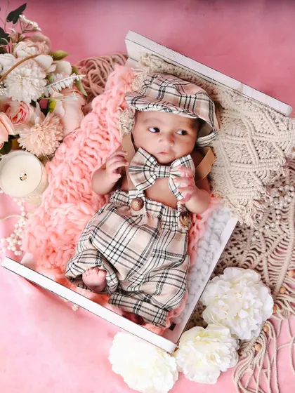 This little guy is awake and looking dapper with his plaid bowtie. This shot shows how we can capture different moods within the same session.