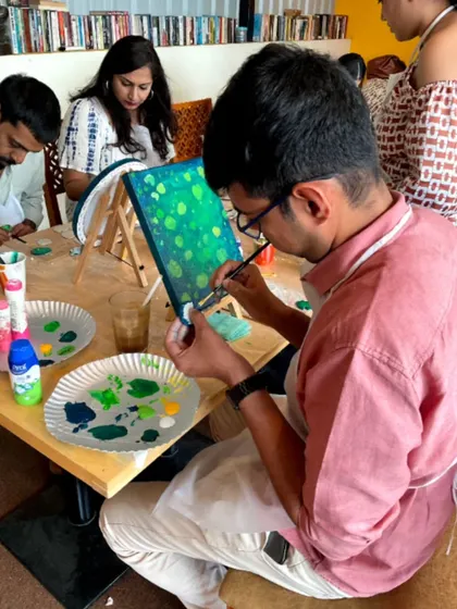 An artist adding the final touches to his Koi Fish painting. The concentration and dedication are evident.
