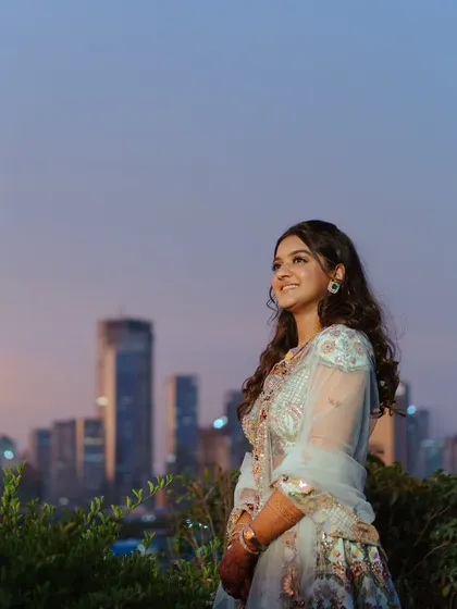 A beautiful twilight shot against the city skyline. Her Sangeet makeup is designed to look stunning in any light, from sunset to the party lights.