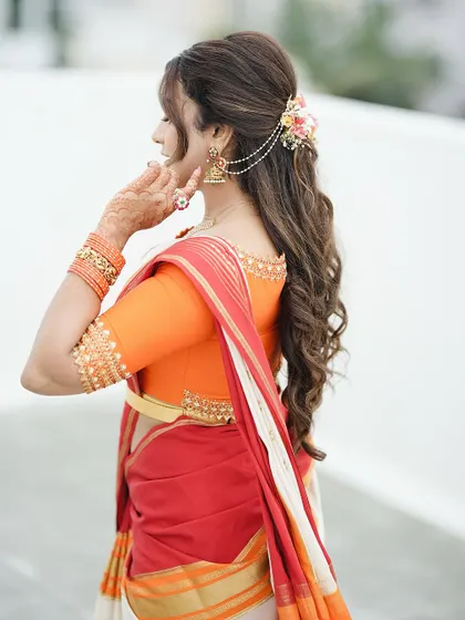 This side profile shows the henna on her hand as she adjusts her hair. It's a reminder that mehendi adorns you from every angle.