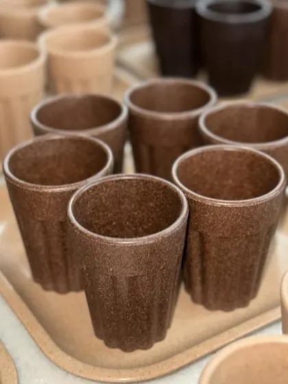 A collection of rustic, eco-friendly chai cups and trays. Made from sustainable materials, these are perfect for a unique, earthy corporate gift that celebrates Indian tradition.