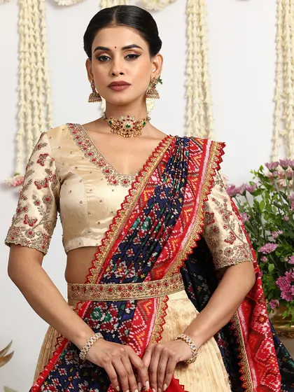 This shot highlights the intricate details of the blouse and the elegant drape of the Bandhani dupatta.
