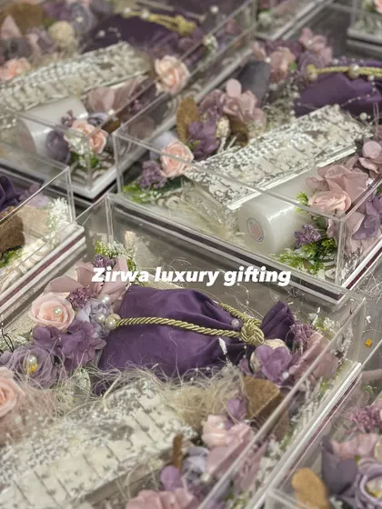 Another look at my lavender-themed wedding favors. These clear acrylic boxes are filled with goodies and decorated with purple flowers and pouches.