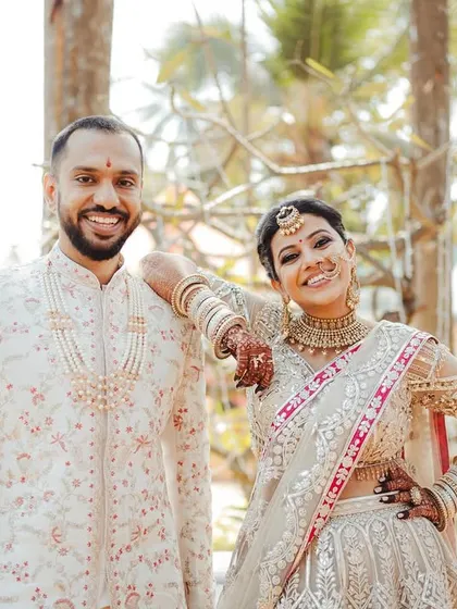 A relaxed and confident portrait of the couple. Jeenal's casual pose, leaning on Chirantan's shoulder, shows a comfortable and cool dynamic between them.