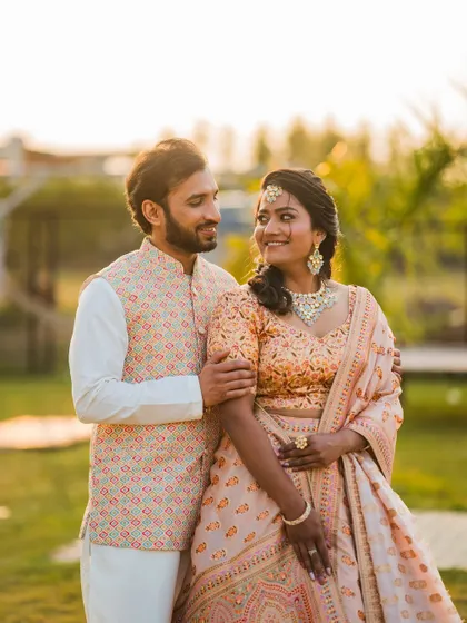 A sweet, candid moment between the couple during their Sangeet or Mehendi event, their smiles showing their deep connection.