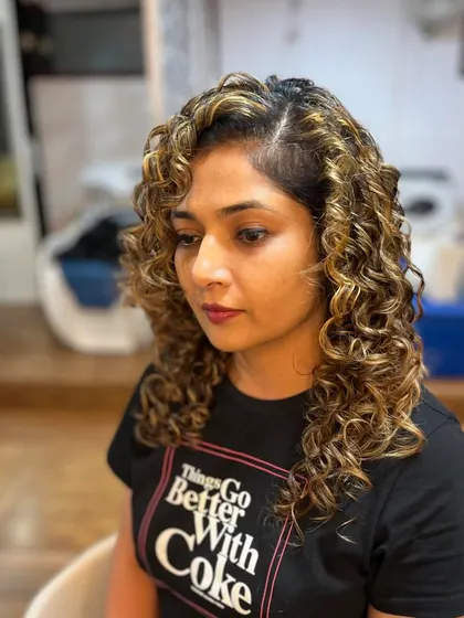 Prathima's curly hair looks vibrant and healthy with the new color.