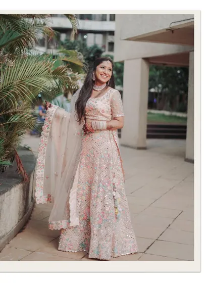 A lovely portrait of the bride-to-be in her beautiful pastel lehenga, captured during her outdoor engagement shoot.