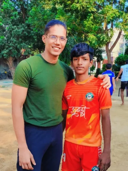 A senior player mentoring a junior one. We encourage a culture of learning and mutual respect.